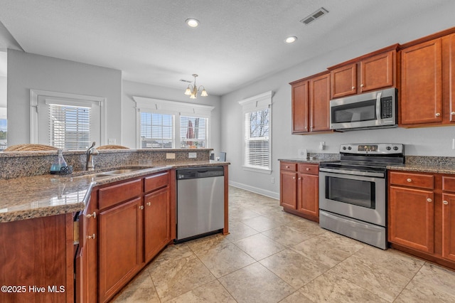 100 Little Acorn Trl, Moyock, NC 27958 - kitchen featuring stainless steel appliances, a sink, a chandelier, recessed lighting, and stone countertops