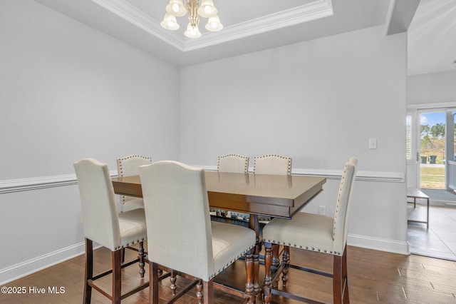 100 Little Acorn Trl, Moyock, NC 27958 - dining area featuring a chandelier, wood finished floors, a tray ceiling, crown molding, and baseboards