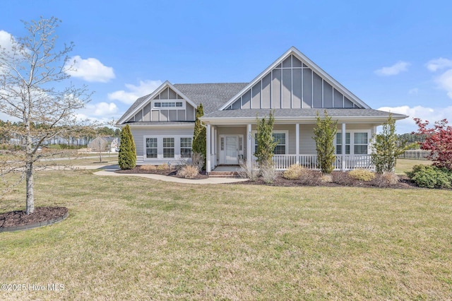 100 Little Acorn Trl, Moyock, NC 27958 - view of front of property with board and batten siding, a front yard, a porch, and a shingled roof