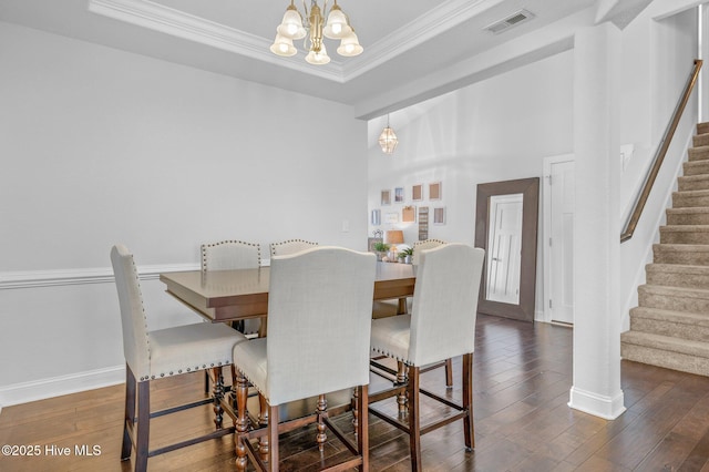 100 Little Acorn Trl, Moyock, NC 27958 - dining space featuring a chandelier, stairway, hardwood / wood-style floors, ornamental molding, and baseboards