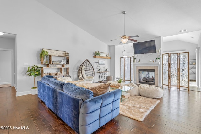 100 Little Acorn Trl, Moyock, NC 27958 - living area featuring hardwood / wood-style floors, a ceiling fan, a tiled fireplace, baseboards, and high vaulted ceiling