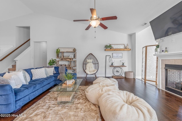 100 Little Acorn Trl, Moyock, NC 27958 - living room featuring ceiling fan, stairway, hardwood / wood-style flooring, a fireplace, and high vaulted ceiling