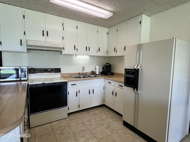 258 Hideaway Rd, Belhaven, NC 27810 - kitchen with white fridge with ice dispenser, range with electric cooktop, under cabinet range hood, stainless steel microwave, and white cabinets