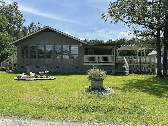 258 Hideaway Rd, Belhaven, NC 27810 - view of front facade featuring stairs, crawl space, a front lawn, and a wooden deck