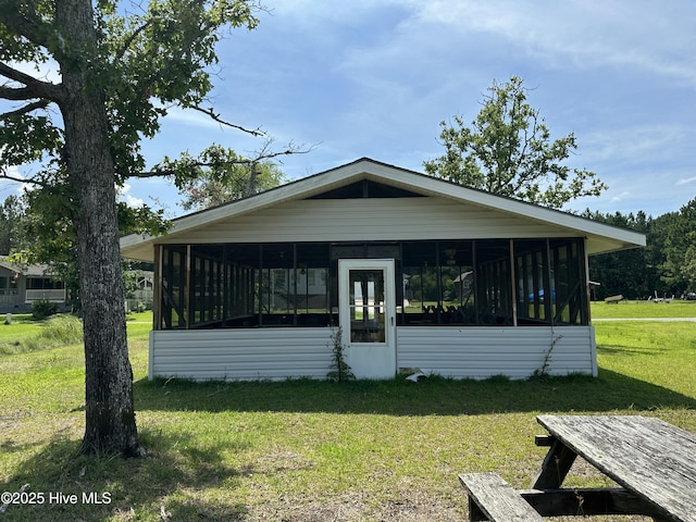 258 Hideaway Rd, Belhaven, NC 27810 - view of front of house featuring a sunroom and a front lawn