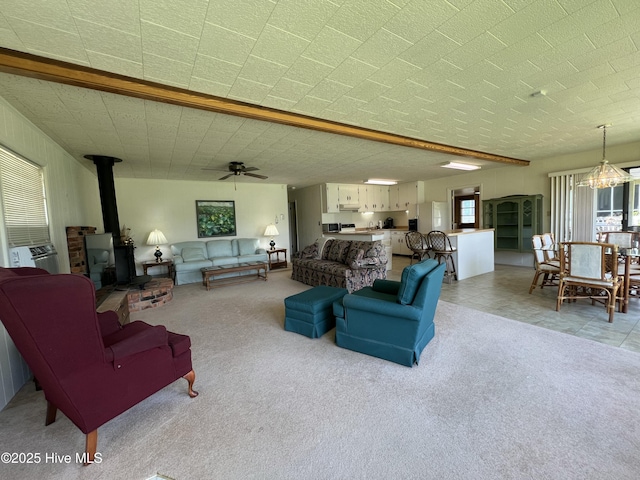 258 Hideaway Rd, Belhaven, NC 27810 - living room featuring a wood stove, plenty of natural light, light carpet, and ceiling fan