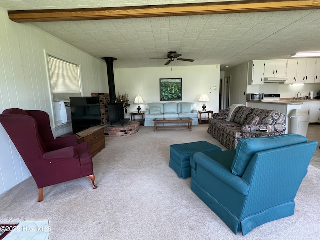 258 Hideaway Rd, Belhaven, NC 27810 - living room featuring light carpet, a wood stove, and a ceiling fan