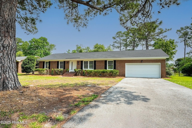 3825 Canterbury Rd, Wilmington, NC 28403 - single story home featuring brick siding, concrete driveway, an attached garage, and a front yard