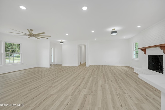 3825 Canterbury Rd, Wilmington, NC 28403 - unfurnished living room with light wood-style flooring, ceiling fan, baseboards, recessed lighting, and a brick fireplace