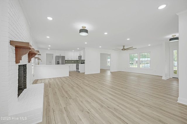 3825 Canterbury Rd, Wilmington, NC 28403 - unfurnished living room with a brick fireplace, recessed lighting, light wood-type flooring, baseboards, and a ceiling fan