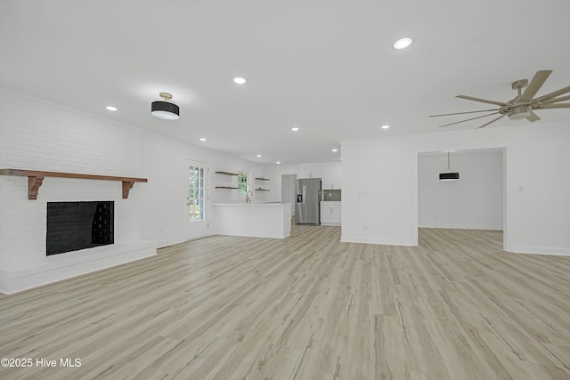 3825 Canterbury Rd, Wilmington, NC 28403 - unfurnished living room featuring a ceiling fan, light wood-style flooring, a sink, recessed lighting, and baseboards