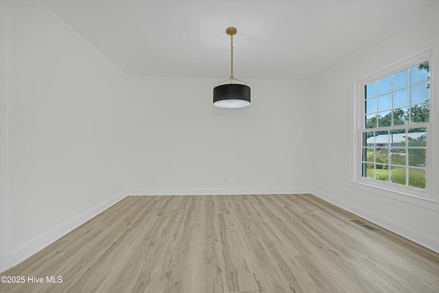 3825 Canterbury Rd, Wilmington, NC 28403 - unfurnished dining area with light wood-type flooring, baseboards, and ornamental molding