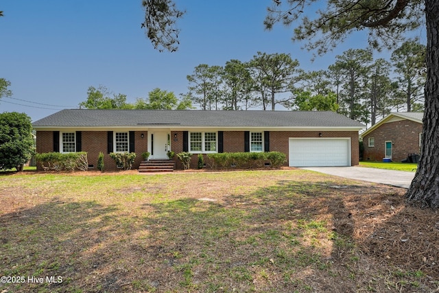 3825 Canterbury Rd, Wilmington, NC 28403 - ranch-style house with an attached garage, driveway, brick siding, and a front lawn