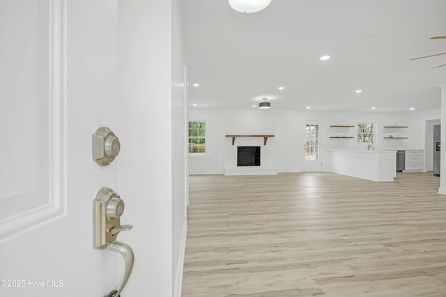3825 Canterbury Rd, Wilmington, NC 28403 - living room featuring plenty of natural light, light wood-type flooring, recessed lighting, a brick fireplace, and a ceiling fan
