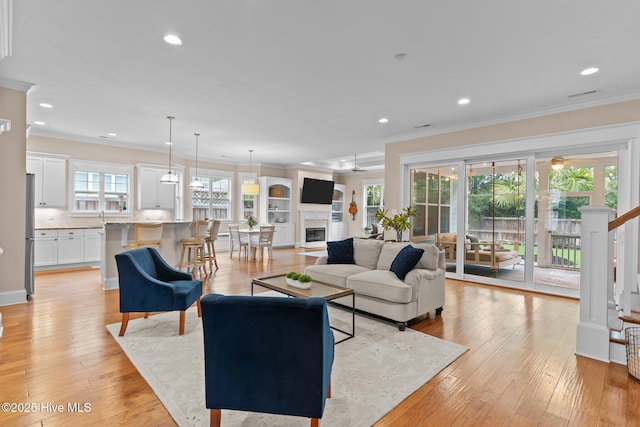 712 Tanbridge Rd, Wilmington, NC 28405 - living room with crown molding, recessed lighting, light wood-type flooring, and ceiling fan