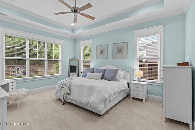 712 Tanbridge Rd, Wilmington, NC 28405 - bedroom with ornamental molding, light carpet, baseboards, a tray ceiling, and a ceiling fan