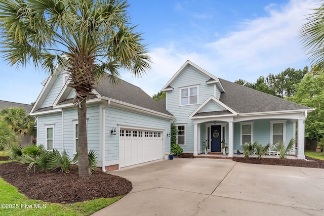 712 Tanbridge Rd, Wilmington, NC 28405 - view of front facade with concrete driveway, covered porch, an attached garage, and roof with shingles