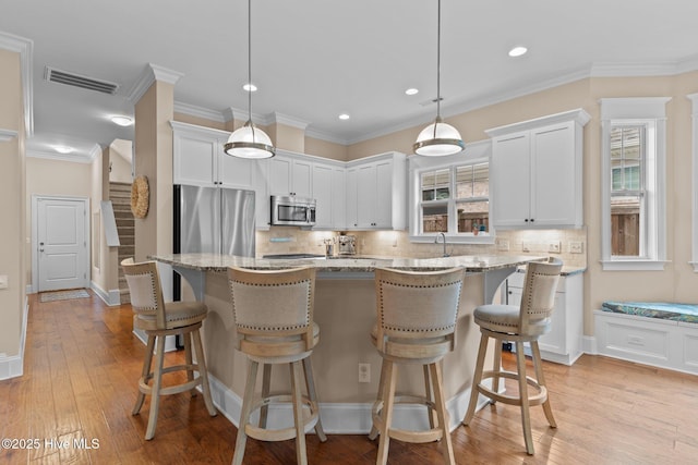 712 Tanbridge Rd, Wilmington, NC 28405 - kitchen with stainless steel appliances, tasteful backsplash, recessed lighting, light stone counters, and white cabinetry
