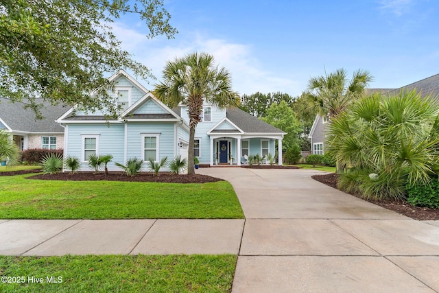 712 Tanbridge Rd, Wilmington, NC 28405 - view of front of house with driveway, a front yard, and covered porch