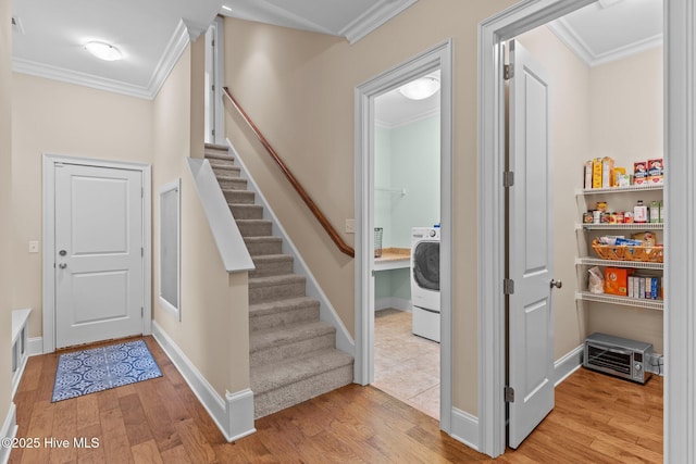 712 Tanbridge Rd, Wilmington, NC 28405 - entryway featuring crown molding, light wood-style floors, stairway, washer / clothes dryer, and baseboards