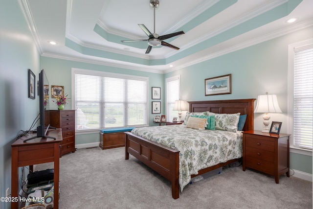 844 E Darden Rd, Faison, NC 28341 - bedroom featuring multiple windows, light carpet, a tray ceiling, ornamental molding, and baseboards