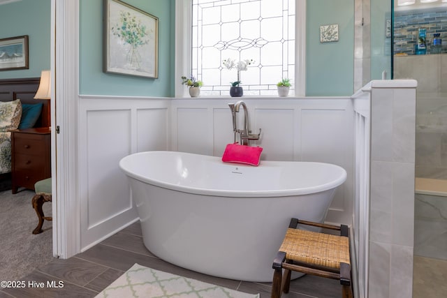 844 E Darden Rd, Faison, NC 28341 - full bath with a decorative wall, tiled shower, a freestanding tub, wainscoting, and connected bathroom