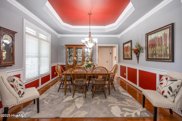 844 E Darden Rd, Faison, NC 28341 - dining room featuring a chandelier, a raised ceiling, wood finished floors, a wainscoted wall, and ornamental molding