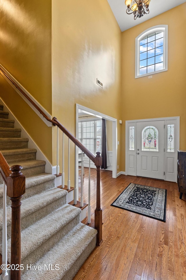 605 Stagecoach Dr, Jacksonville, NC 28546 - foyer entrance with a high ceiling, stairs, a chandelier, wood finished floors, and baseboards