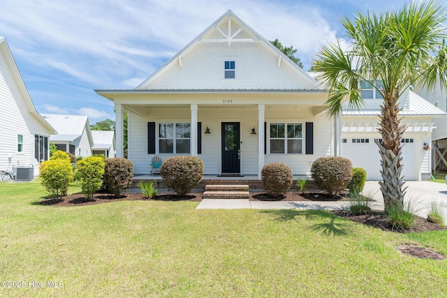 6104 Wayfarer Trl, Wilmington, NC 28409 - view of front of property featuring a garage, covered porch, a front yard, cooling unit, and driveway