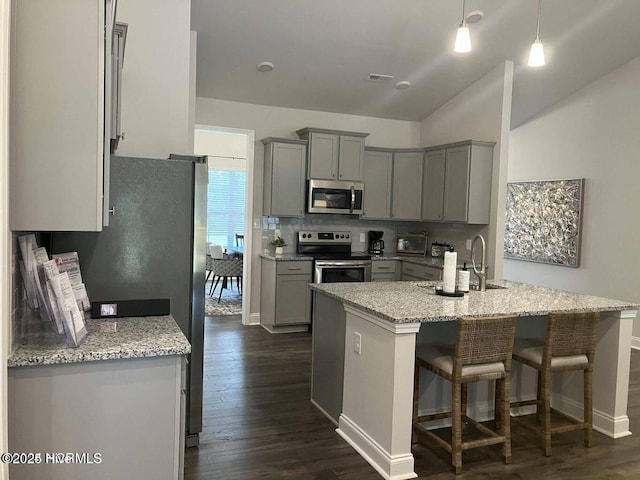 1217 Pelican Dr, New Bern, NC 28560 - kitchen with stainless steel appliances, gray cabinets, dark wood-type flooring, a sink, and lofted ceiling