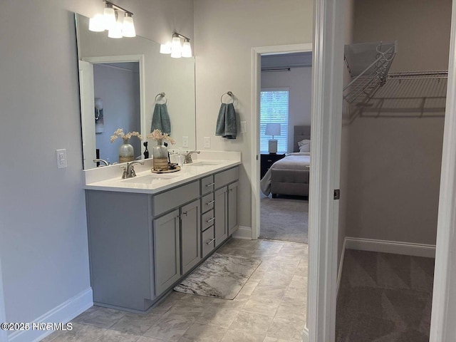 1217 Pelican Dr, New Bern, NC 28560 - ensuite bathroom with double vanity, baseboards, and a walk in closet