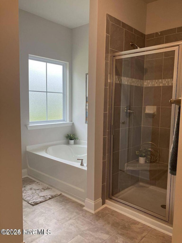 1217 Pelican Dr, New Bern, NC 28560 - bathroom featuring a garden tub, a stall shower, and baseboards