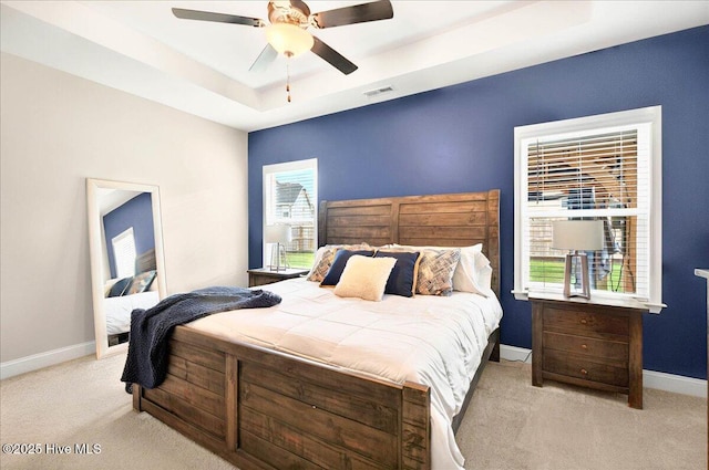 5735 Orchardgrass Rd, Leland, NC 28451 - carpeted bedroom with a raised ceiling, baseboards, and a ceiling fan