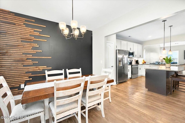 5735 Orchardgrass Rd, Leland, NC 28451 - dining space featuring light wood finished floors and a chandelier
