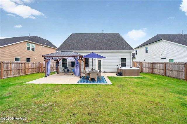 5735 Orchardgrass Rd, Leland, NC 28451 - back of house with a gazebo, a hot tub, and a patio area