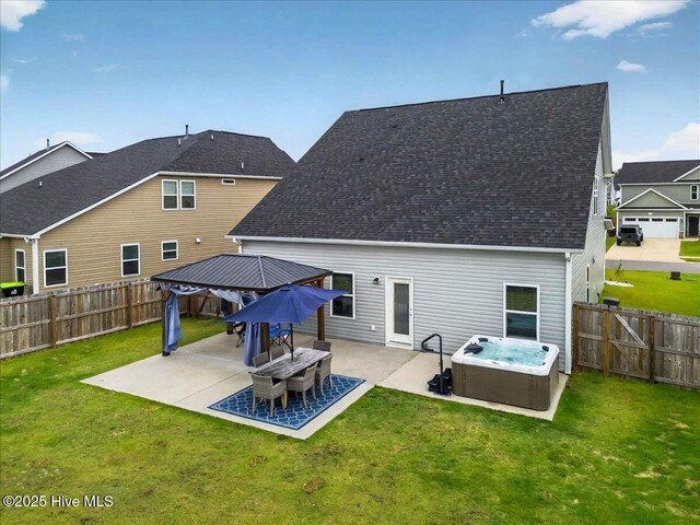5735 Orchardgrass Rd, Leland, NC 28451 - rear view of house with a hot tub, a patio, a gazebo, and roof with shingles