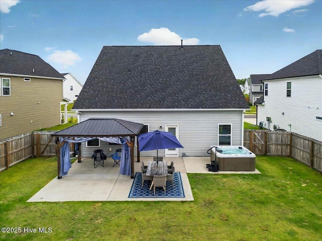 5735 Orchardgrass Rd, Leland, NC 28451 - back of property featuring a gazebo, a hot tub, a patio area, and a shingled roof