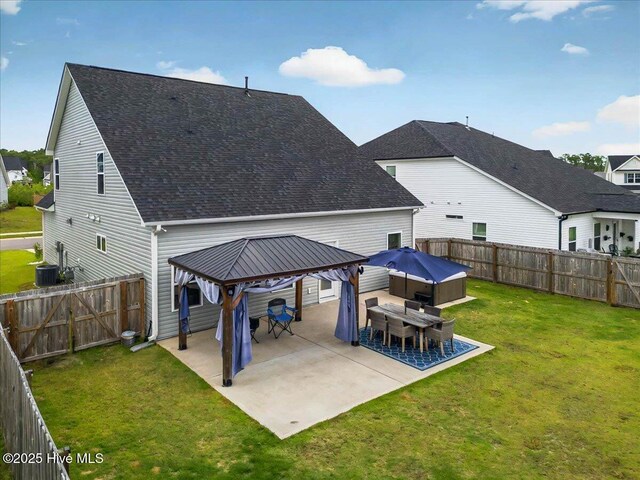 5735 Orchardgrass Rd, Leland, NC 28451 - back of house with a gazebo, a shingled roof, a patio area, central AC, and a hot tub