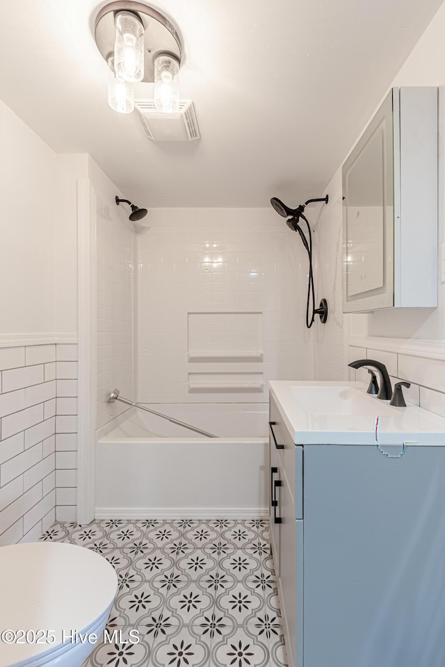 105 Queens Rd, Jacksonville, NC 28540 - full bathroom featuring tile walls, washtub / shower combination, vanity, and toilet