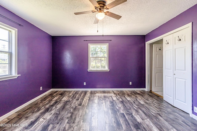 105 Queens Rd, Jacksonville, NC 28540 - unfurnished bedroom with a textured ceiling, wood finished floors, baseboards, ceiling fan, and a closet