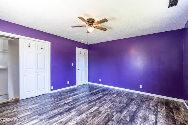 105 Queens Rd, Jacksonville, NC 28540 - unfurnished bedroom with wood finished floors, baseboards, a closet, a textured ceiling, and a ceiling fan