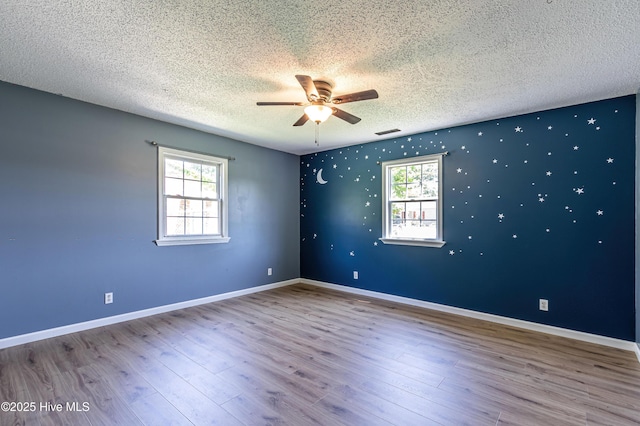105 Queens Rd, Jacksonville, NC 28540 - unfurnished room with a ceiling fan, a textured ceiling, healthy amount of natural light, wood finished floors, and baseboards