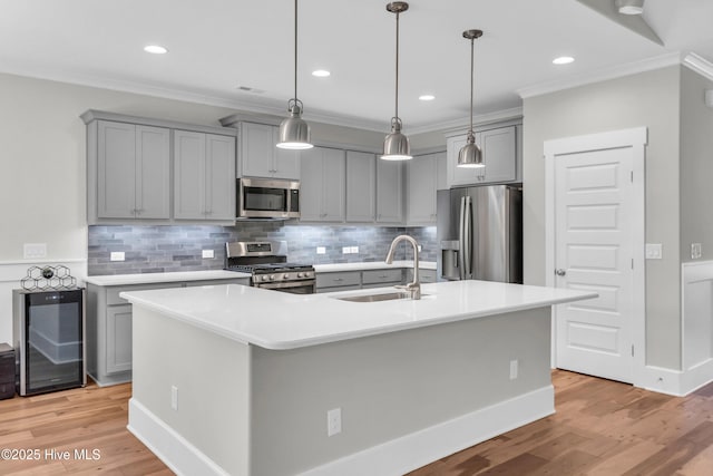 2676 W Timber Crest Dr, Leland, NC 28451 - kitchen with appliances with stainless steel finishes, beverage cooler, gray cabinetry, a sink, and ornamental molding