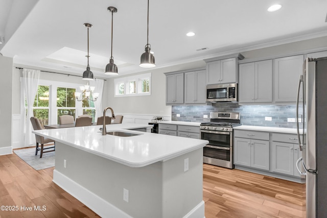 2676 W Timber Crest Dr, Leland, NC 28451 - kitchen featuring appliances with stainless steel finishes, gray cabinetry, a sink, a kitchen island with sink, and recessed lighting