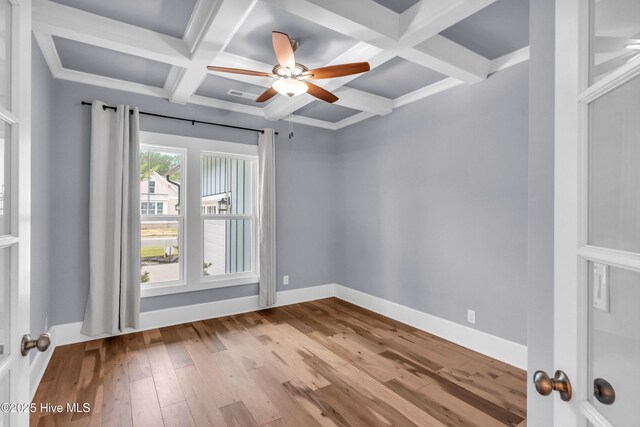 2676 W Timber Crest Dr, Leland, NC 28451 - empty room with coffered ceiling, wood-type flooring, a ceiling fan, beamed ceiling, and baseboards