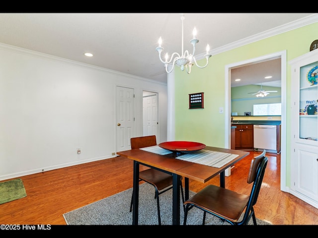 4043 Brick Path Ln SE, Southport, NC 28461 - dining space featuring crown molding, a chandelier, light wood-style floors, a ceiling fan, and baseboards