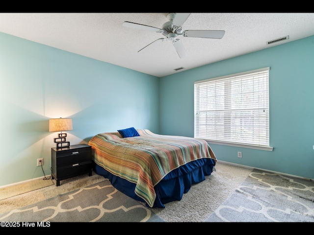 4043 Brick Path Ln SE, Southport, NC 28461 - bedroom with carpet flooring, baseboards, a ceiling fan, and a textured ceiling