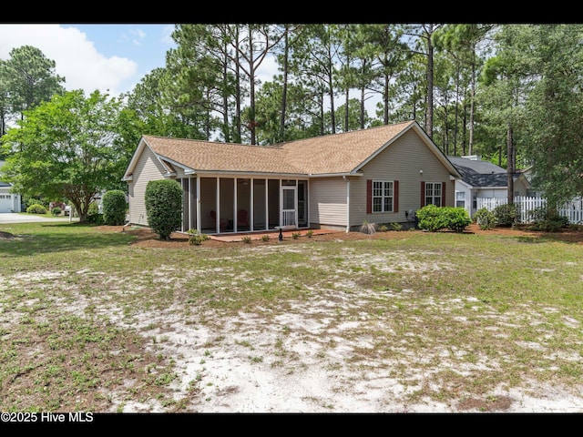4043 Brick Path Ln SE, Southport, NC 28461 - view of front facade with a sunroom and a shingled roof