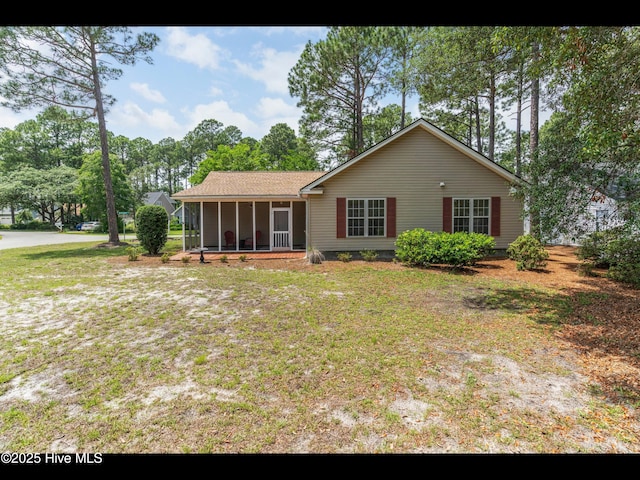 4043 Brick Path Ln SE, Southport, NC 28461 - view of front of house with a sunroom and a front lawn