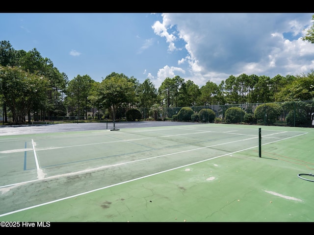 4043 Brick Path Ln SE, Southport, NC 28461 - view of tennis court featuring view of wooded area
